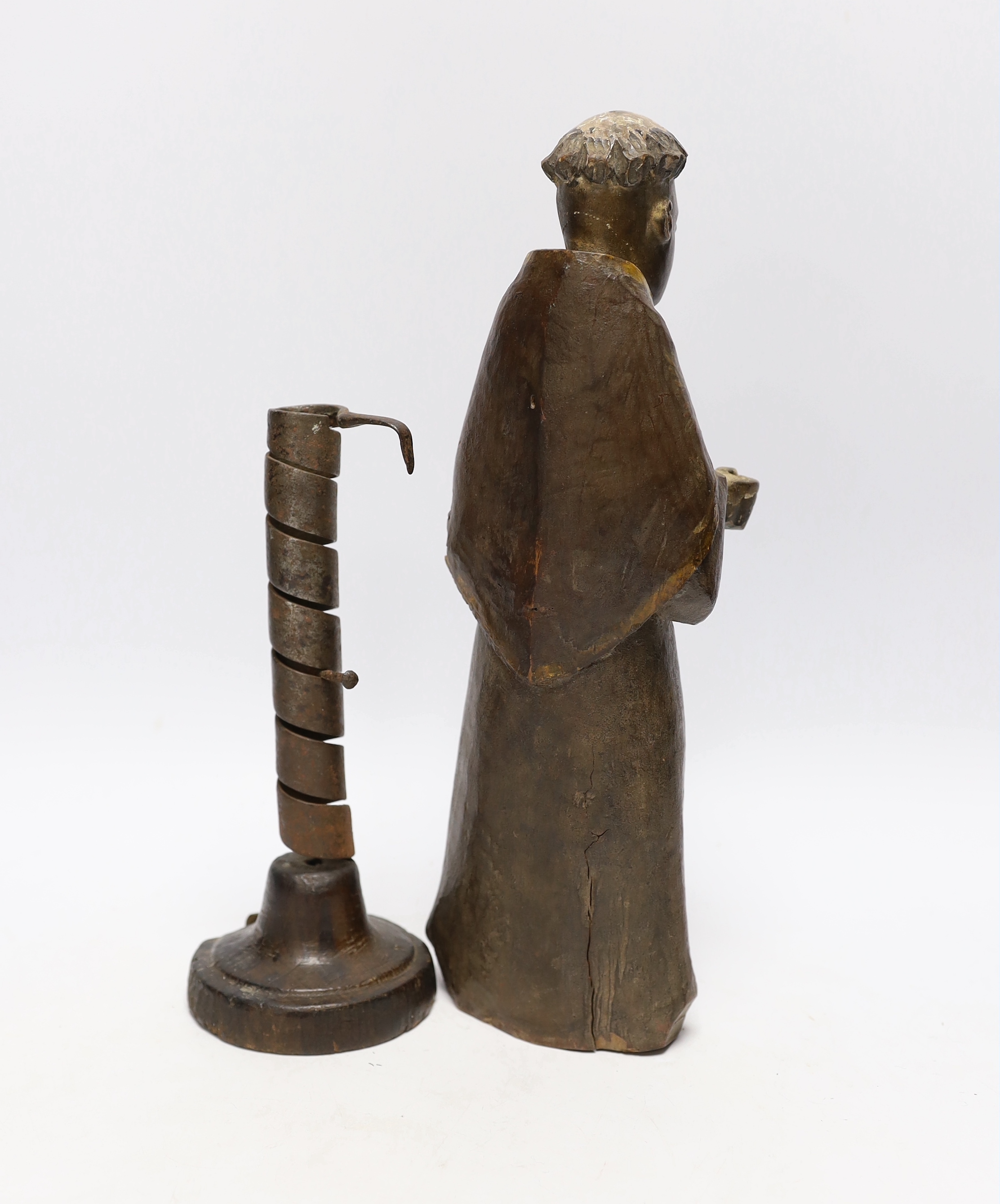 An 18th century Spanish carved and painted wood figure of a monk and 18th century ‘rat de cave’ candlestick, wooden knight 32cm high